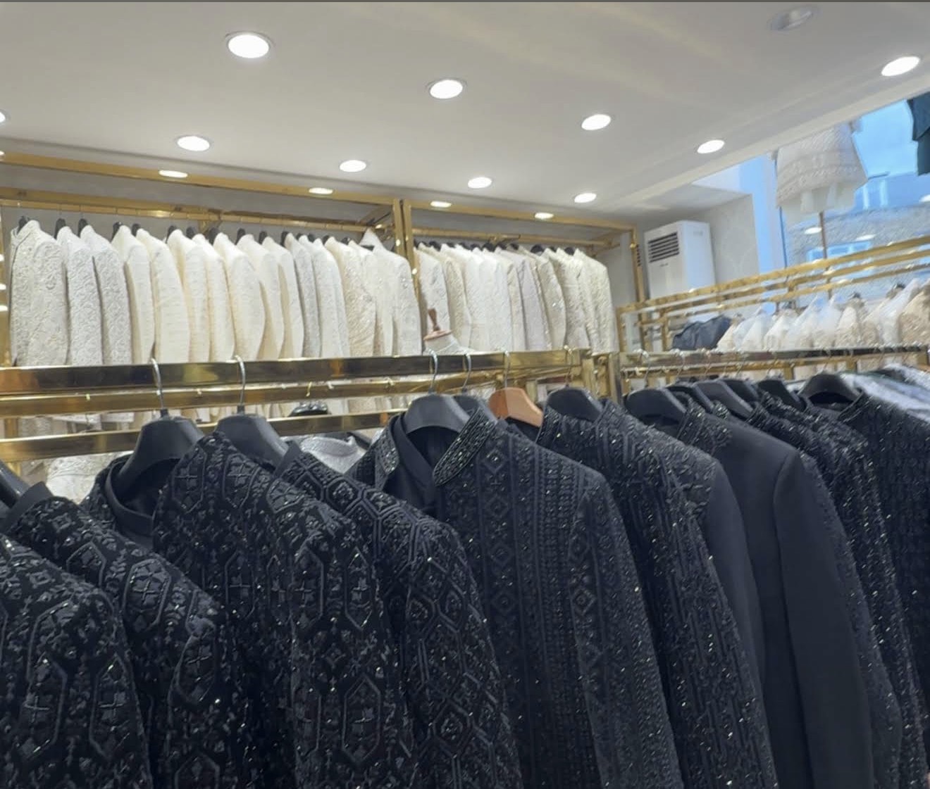 Rails of black and ivory sherwanis inside Nawaab Men's Exclusive